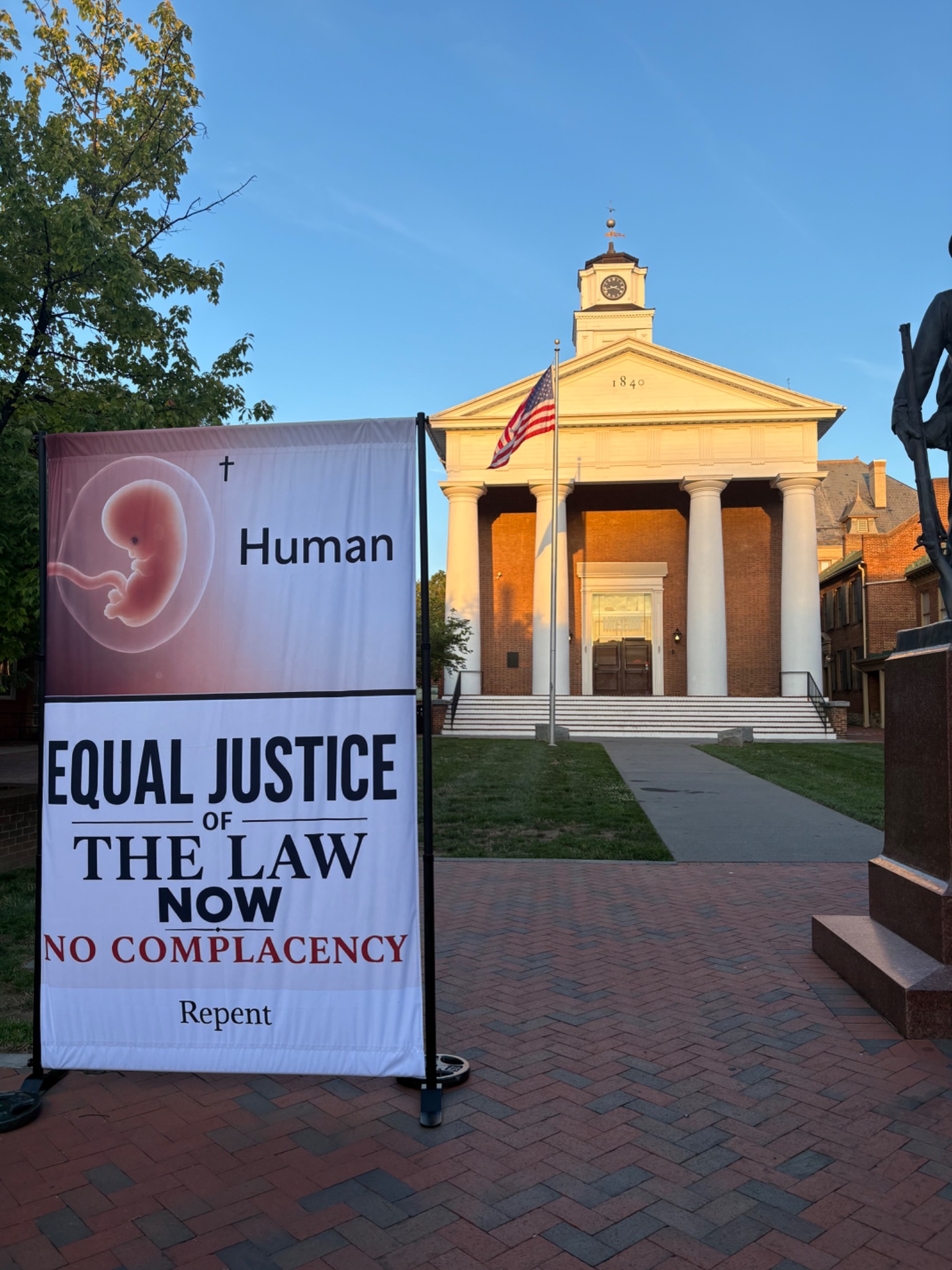 Equal Justice of the Law Now advocacy banner displayed in a public square